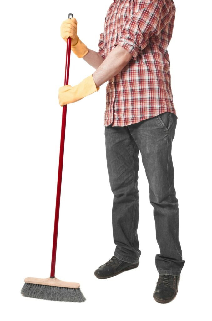 young worker with a broom